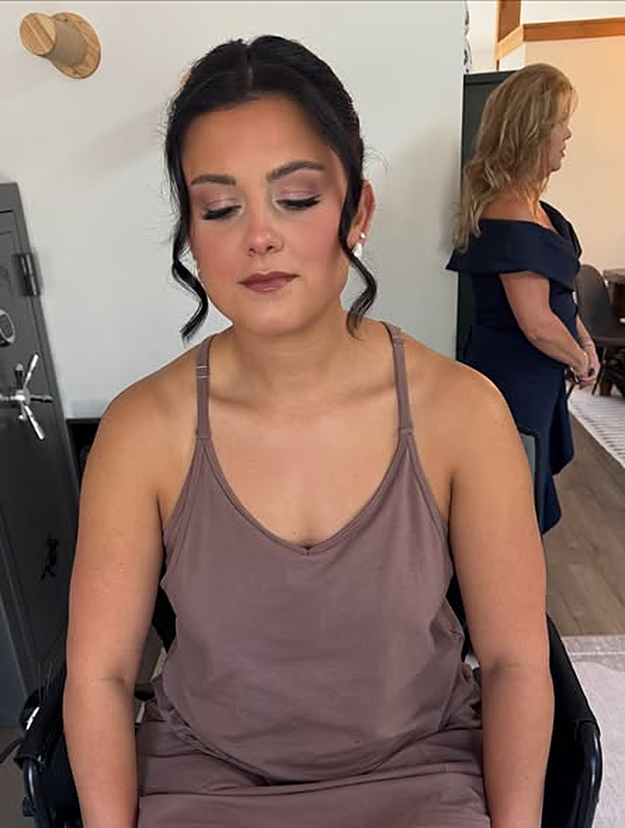 Client with soft glam makeup and a sleek updo
