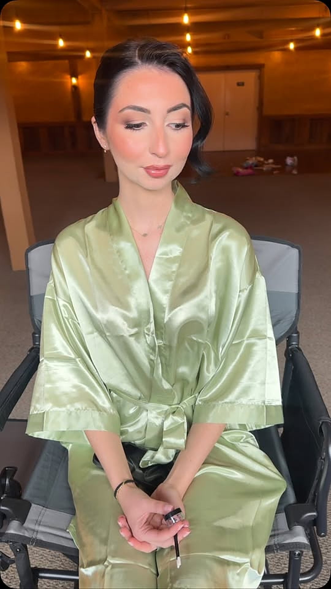 Client in a satin getting-ready set with soft glam makeup